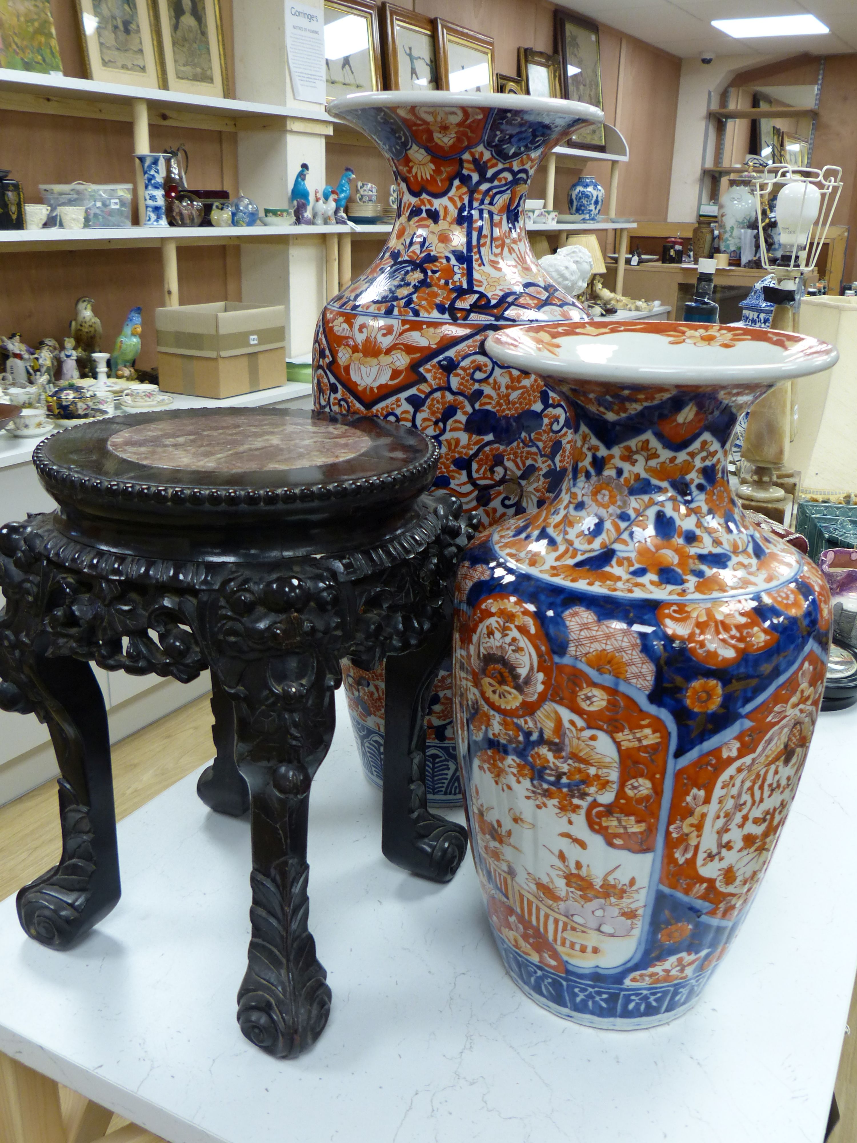 Four Japanese Imari vases, Meiji period, together with a carved hardwood and marble inset stand, tallest vase 61.5cm
